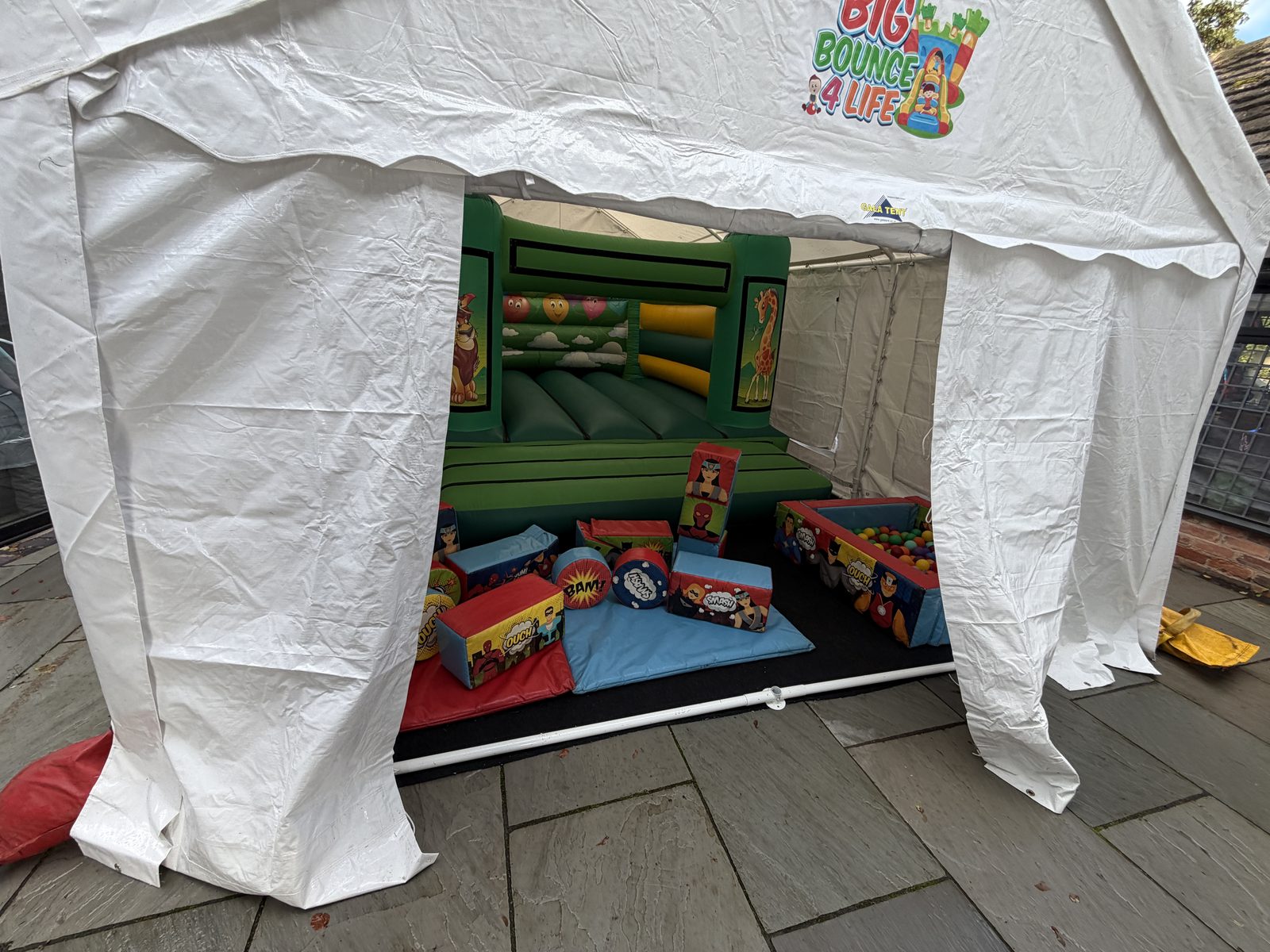 Patio marquee holding a bouncy castle and soft play, the full Northfield package