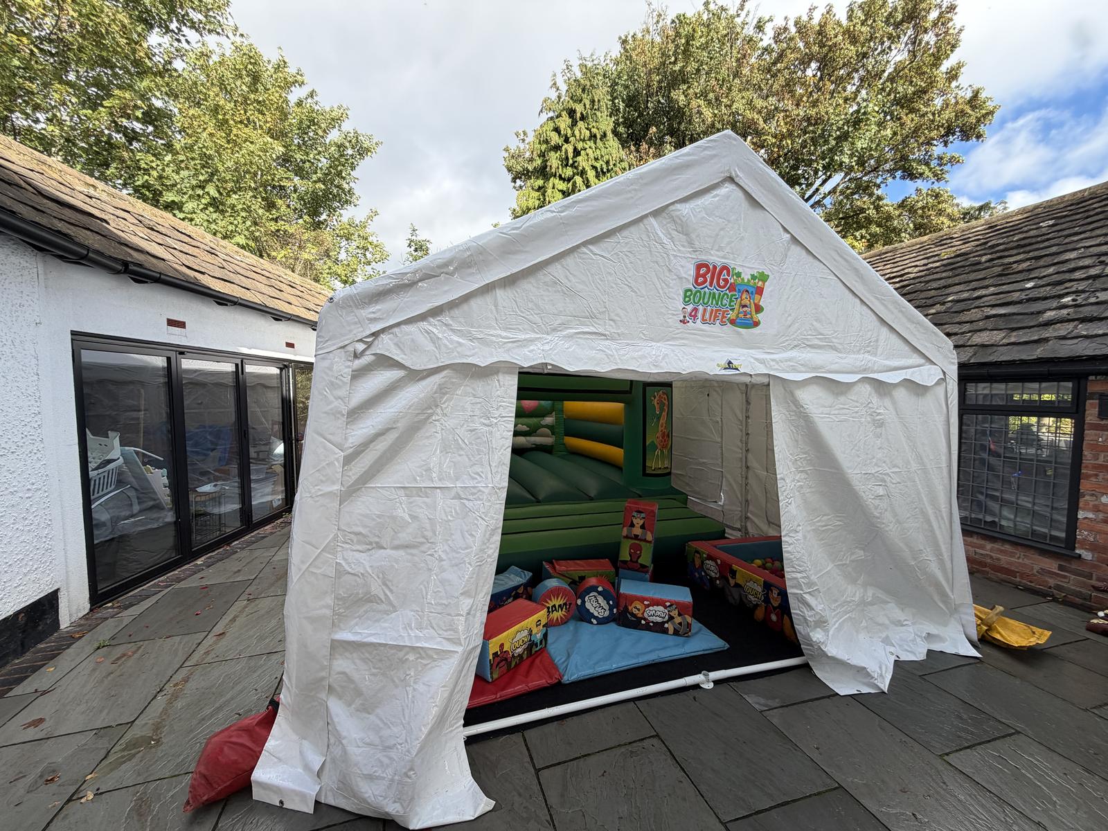 Marquee by a house with a castle and soft play inside, the full package for Solihull homes